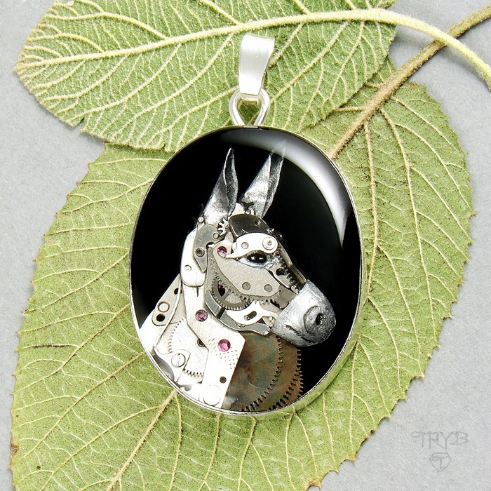 Silver pendant with a donkey sculpture of watch parts